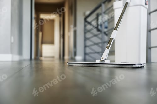 Preview: Cleaning supplies: mop and bucket with wringer on wooden laminate floor