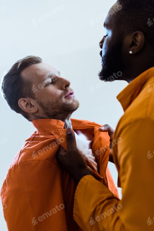 Preview: african american prisoner threatening cellmate isolated on white