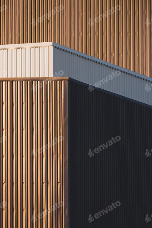 Preview: Evening sunlight and shadow on surface of gray and white corrugated metal factory building