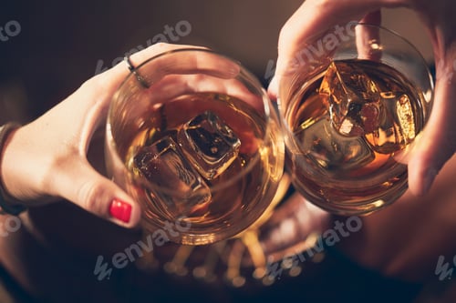 Preview: Closeup shot of people clinking glasses with alcohol at a toast