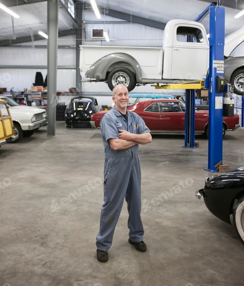 Preview: Portrait of a senior caucasian male owner of an antique car repair shop