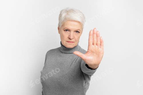 Preview: Senior lady gesturing stop with her hand