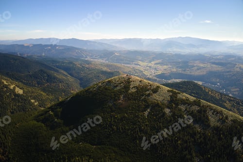 Preview: Aerial landscape view of high peaks with dark pine forest trees in wild mountains