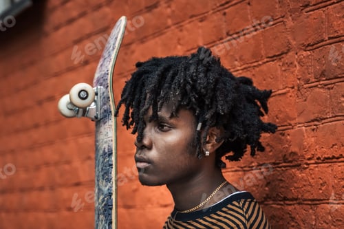Preview: Portrait of young handsome stylish black man with natural hair dreadlocks. Afroamerican guy. Wall pa