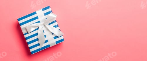 Preview: Top view Christmas present box with white bow on living coral background with copy space
