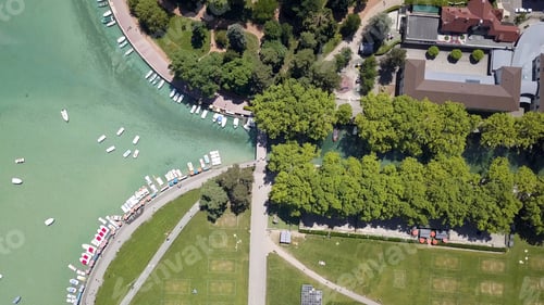 Preview: Aerial top view of the city canal with tourist boats, green trees and houses in a summer sunny day