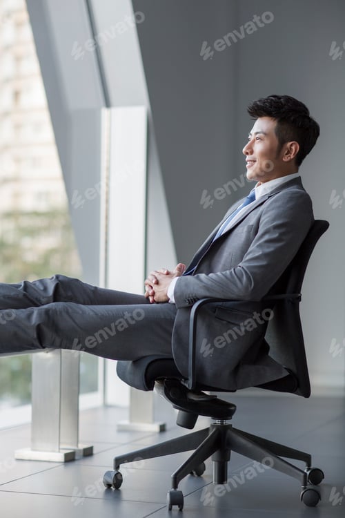 Preview: Young Chinese businessman looking at view