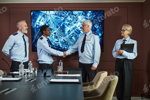 Preview: Middle Aged Multiethnic Politicians Shaking Hands during Meeting in Boardroom