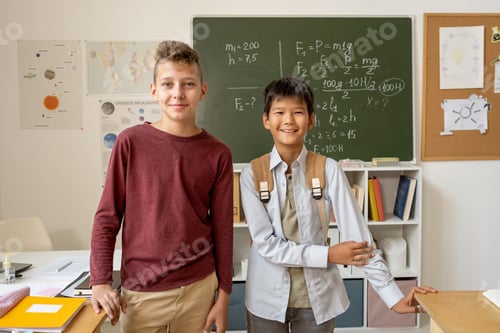 Preview: Two youthful boys of various ethnicities standing by blackboard
