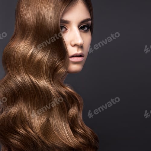 Preview: Beautiful brunette girl with a perfectly curls hair and classic make-up. Beauty face.