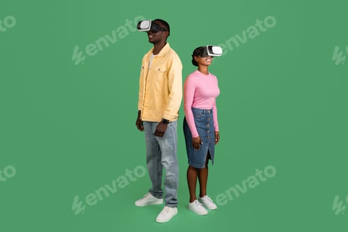 Preview: African american man and woman using VR glasses, green background
