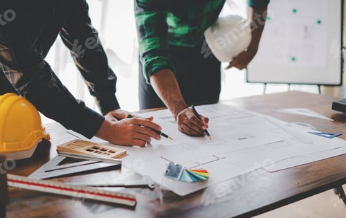 Preview: Engineers work as a team with blueprints for architectural plans. Engineer sketching construction pr