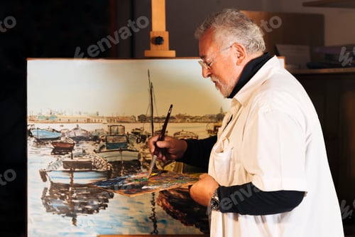 Preview: Old man artist painting oils in his studio.