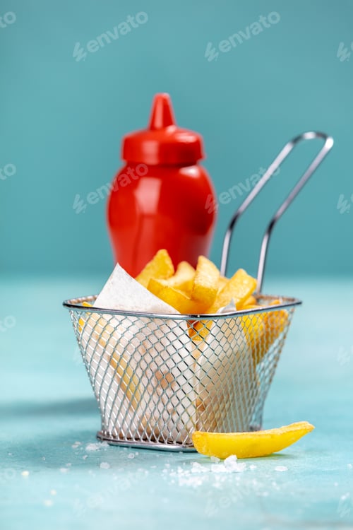 Preview: French fries and ketchup on blue background