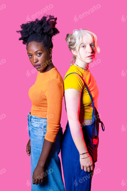 Preview: Two young diverse multicultural caucasian and black women best friends standing isolated