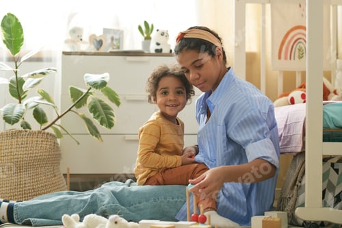 Preview: Mother Sitting on Floor with Her Child Engaging in Playtime