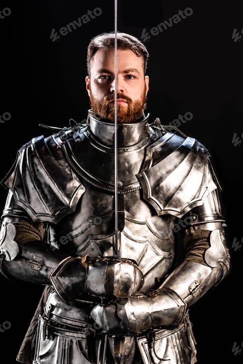 Preview: handsome knight in armor holding sword isolated on black
