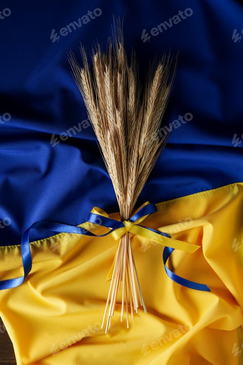 Preview: Ukrainian flag with spikelets with ribbons on wooden background