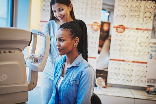 Preview: Serious black woman takes eye exam in optical shop