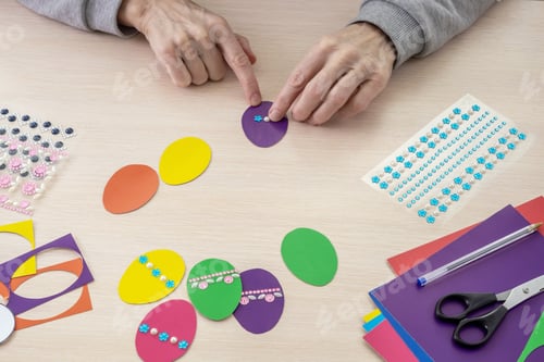 Preview: women's hands make Easter decor out of paper. Handmade