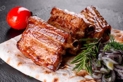 Preview: Fried ribs with rosemary, onion, sauce on a concrete background