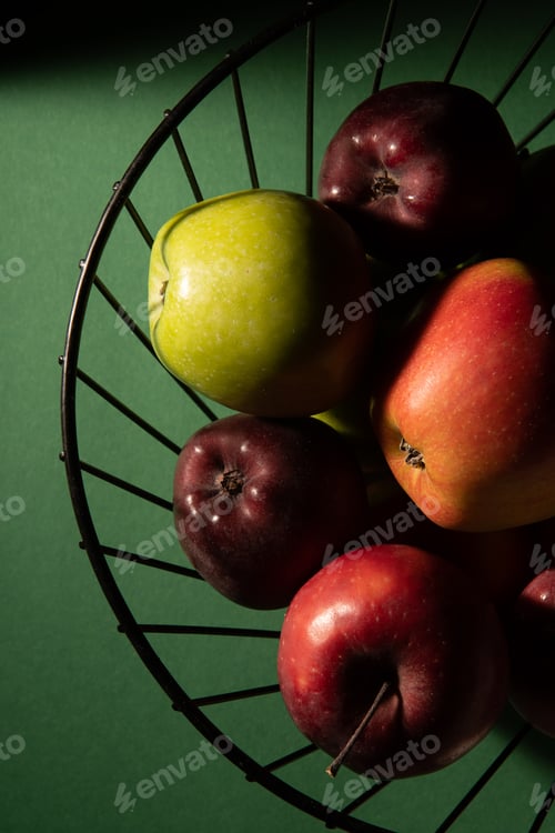 Preview: Basket with juicy fresh apples on a dark green background. Top view, studio photo.