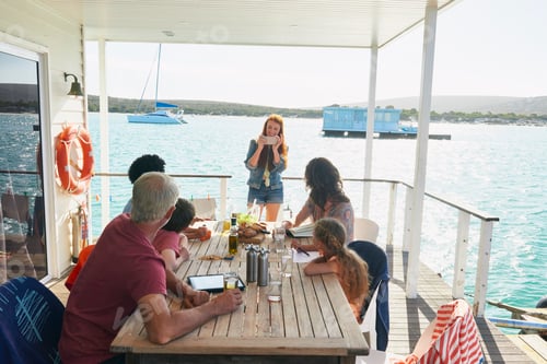 Preview: Family gathered at table on houseboat sun deck, Kraalbaai, South Africa