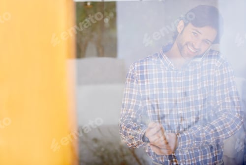 Preview: Man Smiling and Talking on Phone Inside