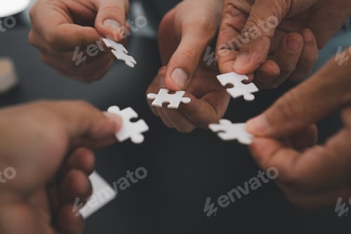 Preview: Business team handle a piece of white puzzles that are about to drop to get a complete worksheet