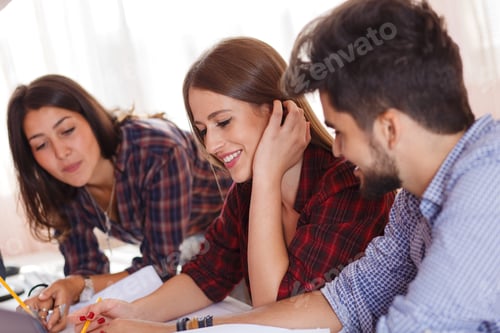 Preview: Three young students learning together at home.