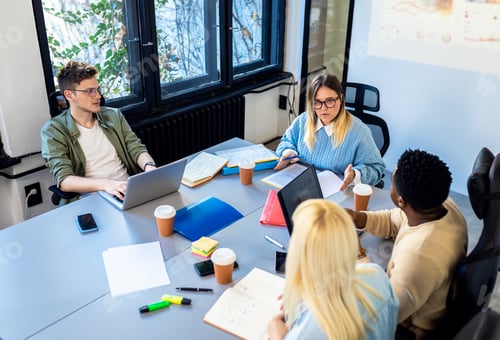 Preview: Diverse group of young business people working on new project together in office.