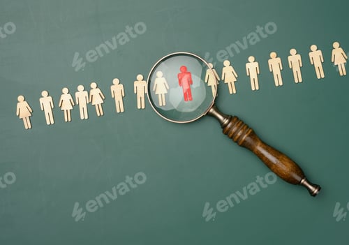Preview: Wooden men and a magnifying glass on a green background