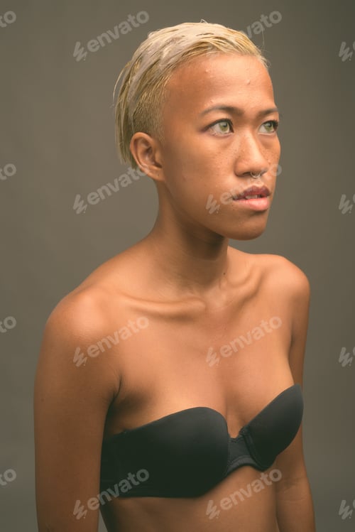 Preview: Young beautiful rebellious woman with short hair against gray background