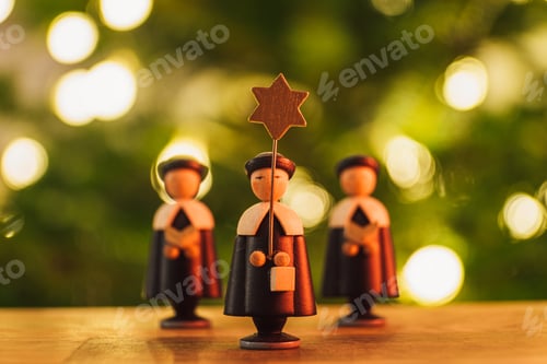 Preview: Selective focus shot of a small wooden Christmas star singers toys