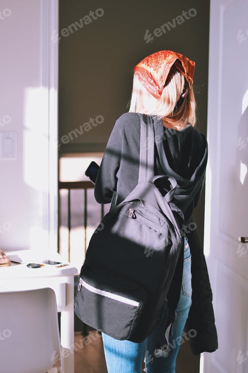 Preview: Young teenage girl with backpack wearing bandana on her head leaving her room ready for school