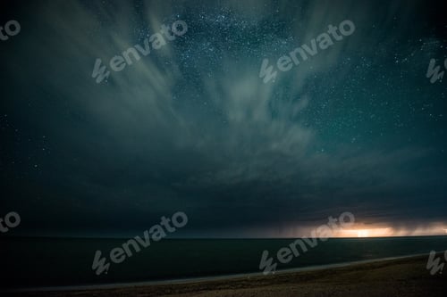 Preview: Starry night with thunderstorm and lightning over the sea