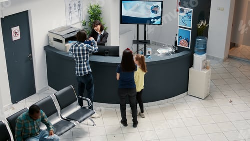 Preview: Busy hospital reception and waiting area with diverse patients