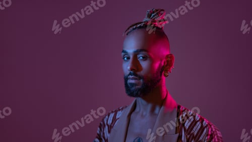 Preview: Neon light studio close-up portrait handsome black gay man looking camera.