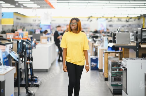 Preview: Portrait of happy African American girl in electronics store. A store of modern household appliances