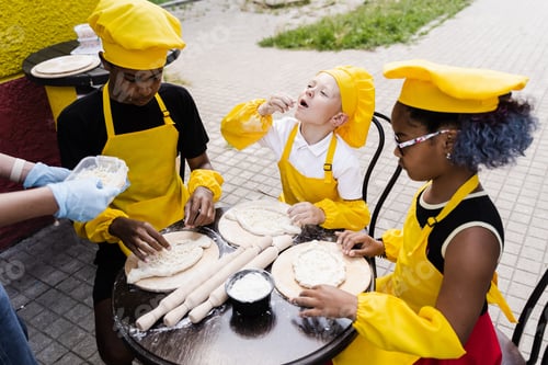 Preview: Kids cooking dough together, multinational fun activity in chef uniforms