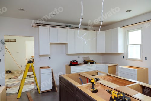 Preview: In a set of furniture under construction, white kitchen wooden cabinets were installed