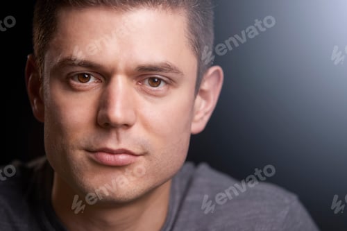 Preview: Close up portrait of a young white man looking to camera