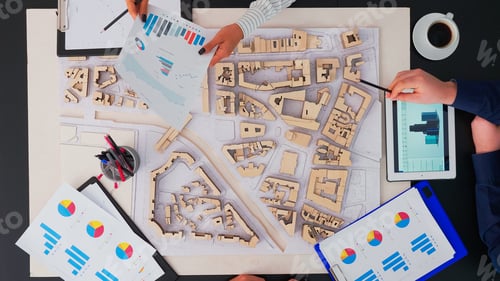 Preview: architects with buildings prototype working at office table