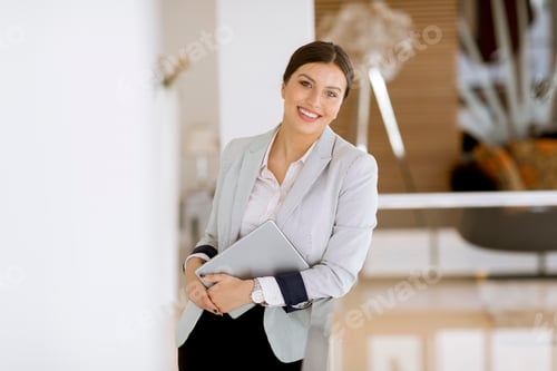 Preview: Young woman with a tablet in the office