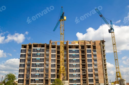 Preview: Building site with two industrial tower cranes working at construction