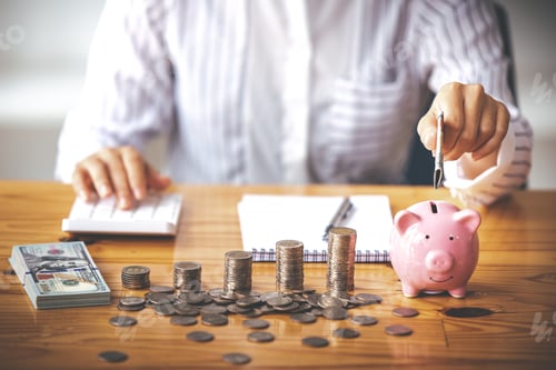 Preview: businessman holding a coin in a piggy bank On a table with sunlight. Money Saving Ideas for Financia