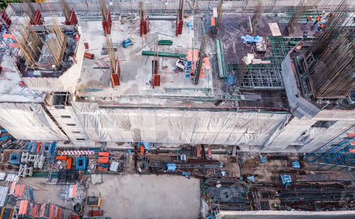 Preview: Aerial view of busy industrial construction site workers working. Development high rise building.
