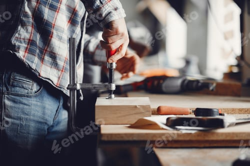 Preview: The carpenter works with a tree