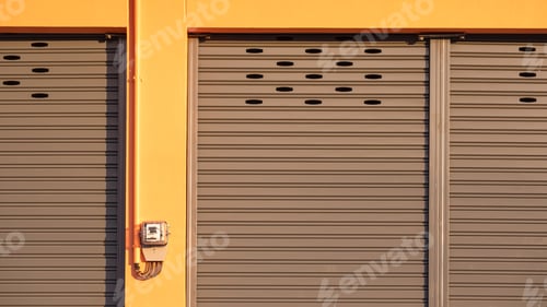 Preview: Roller shutter entrance door with electric meter and in front of rental shophouse building