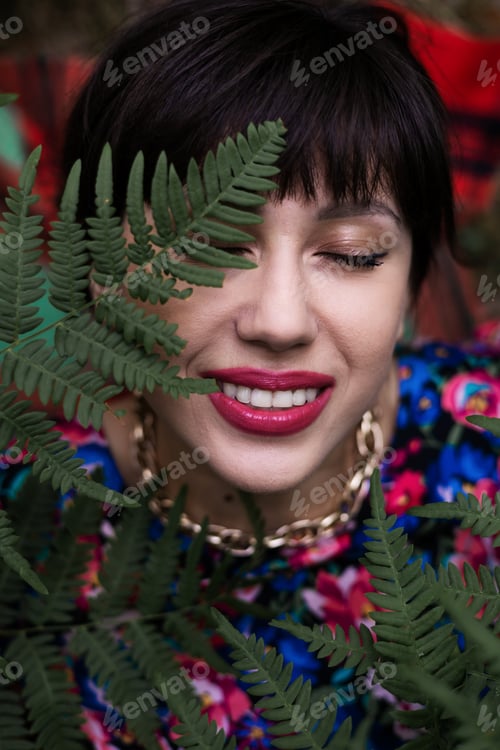 Preview: Romantic portrait of a woman in a fern in the forest. Art woman natural makeup resting in nature. Gr